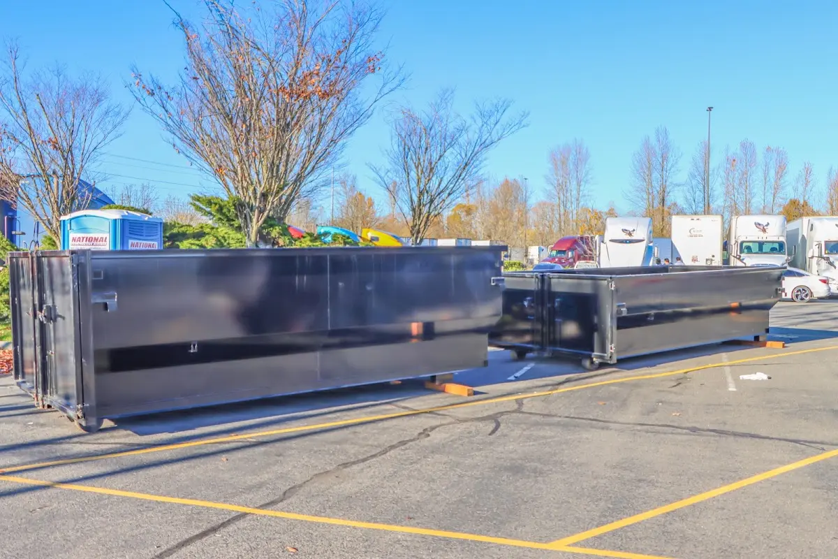 Professional dumpster rental service with roll-off container on residential driveway in Perry Hall